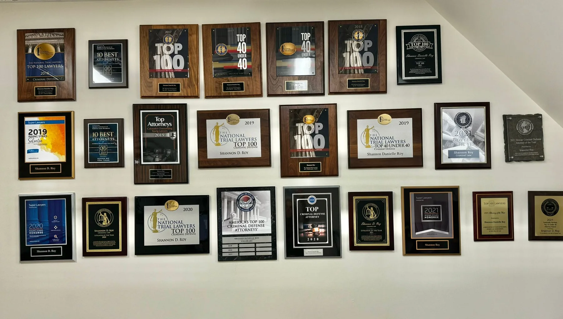 Wall of award plaques at Roy Law Firm